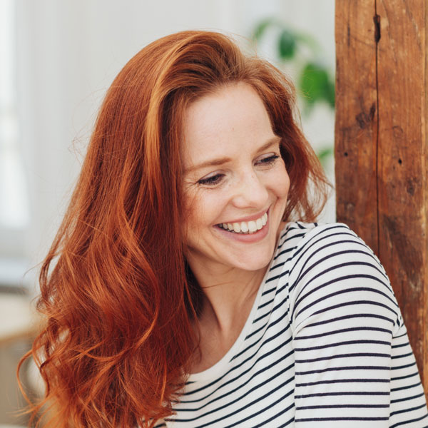 Laughing young woman with red hair