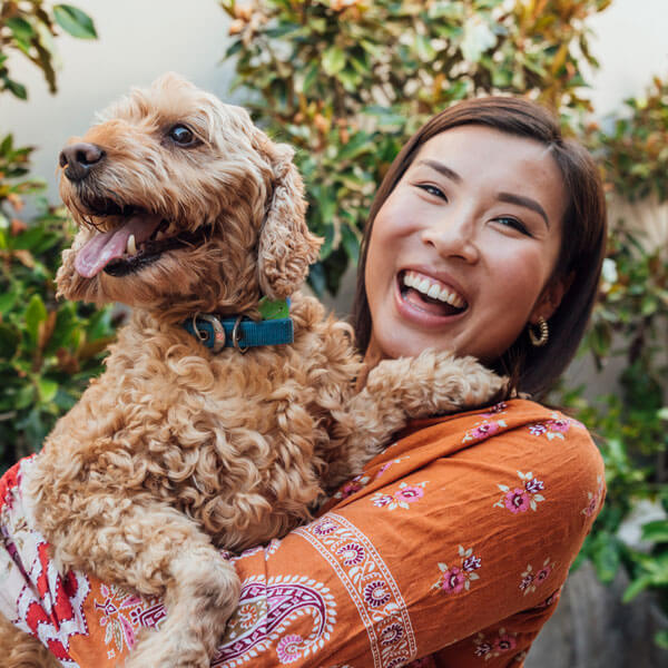 smiling woman holding dog