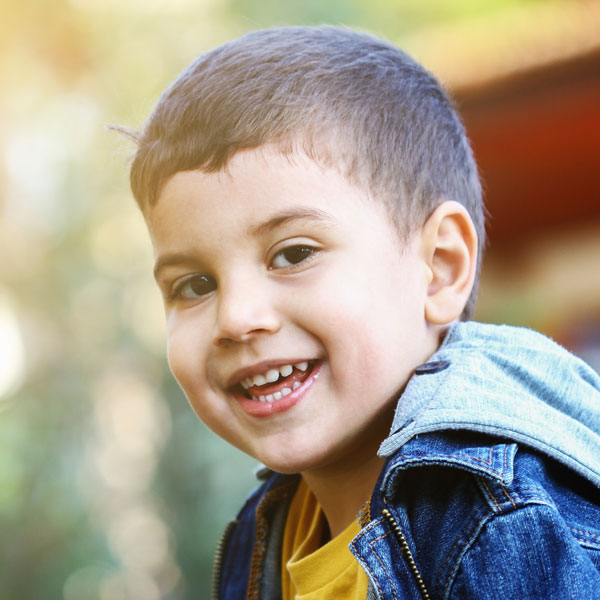 Happy little boy looking at camera and smiling