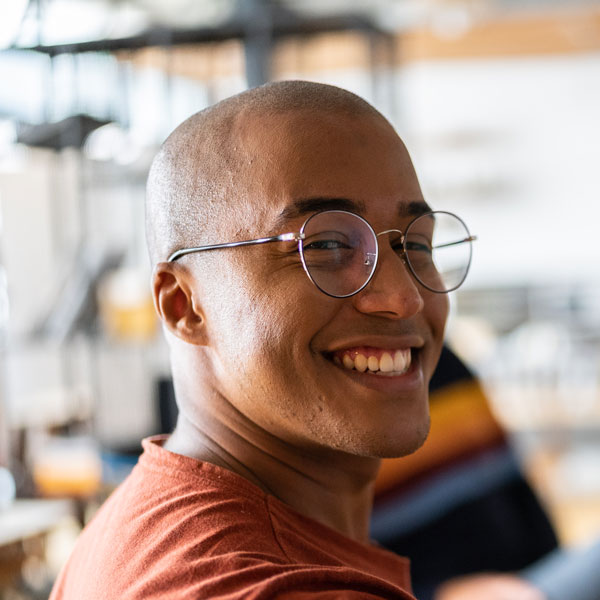 Young man looking over shoulder and smiling