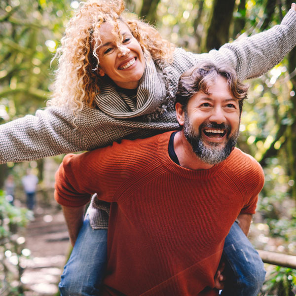 Adult couple laughing and smiling outdoors